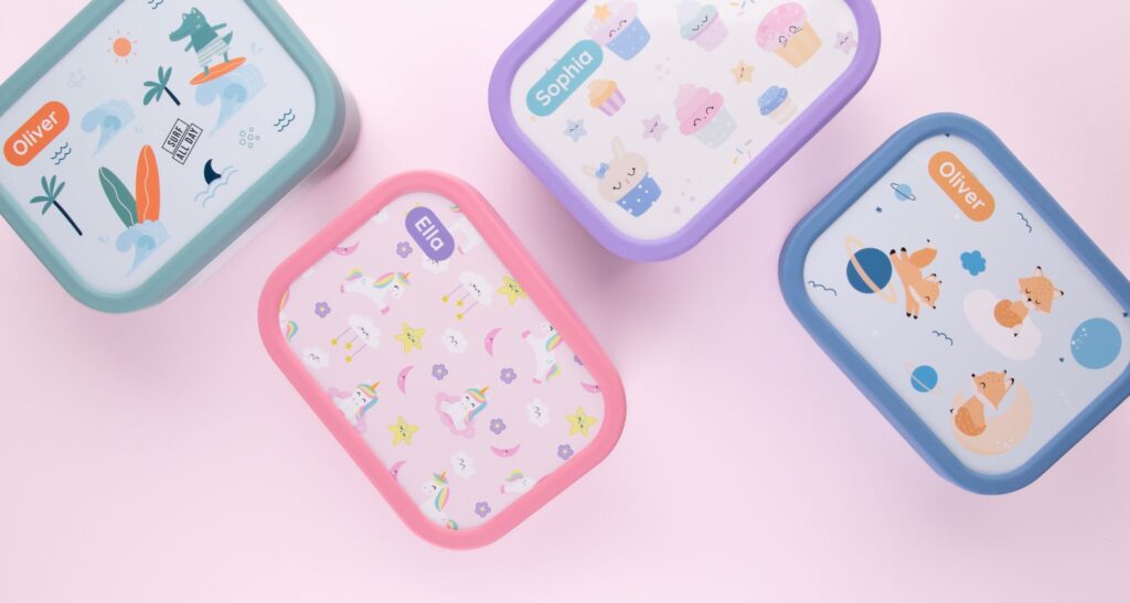 Four personalized lunch boxes in different colors